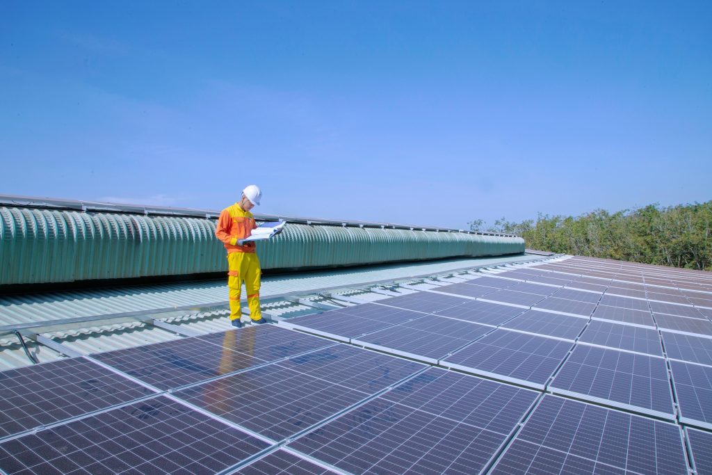 A renewable energy engineer inspecting solar panels under the bright sun, ensuring sustainable energy solutions. As the world shifts to green energy, this profession is among the 7 fastest-growing careers to watch in 2025, helping drive the future of sustainability.